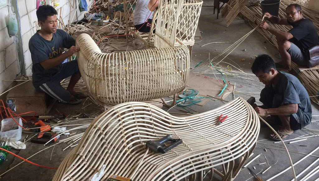 Luna artisans weaving rattan furniture in our factory in Bali